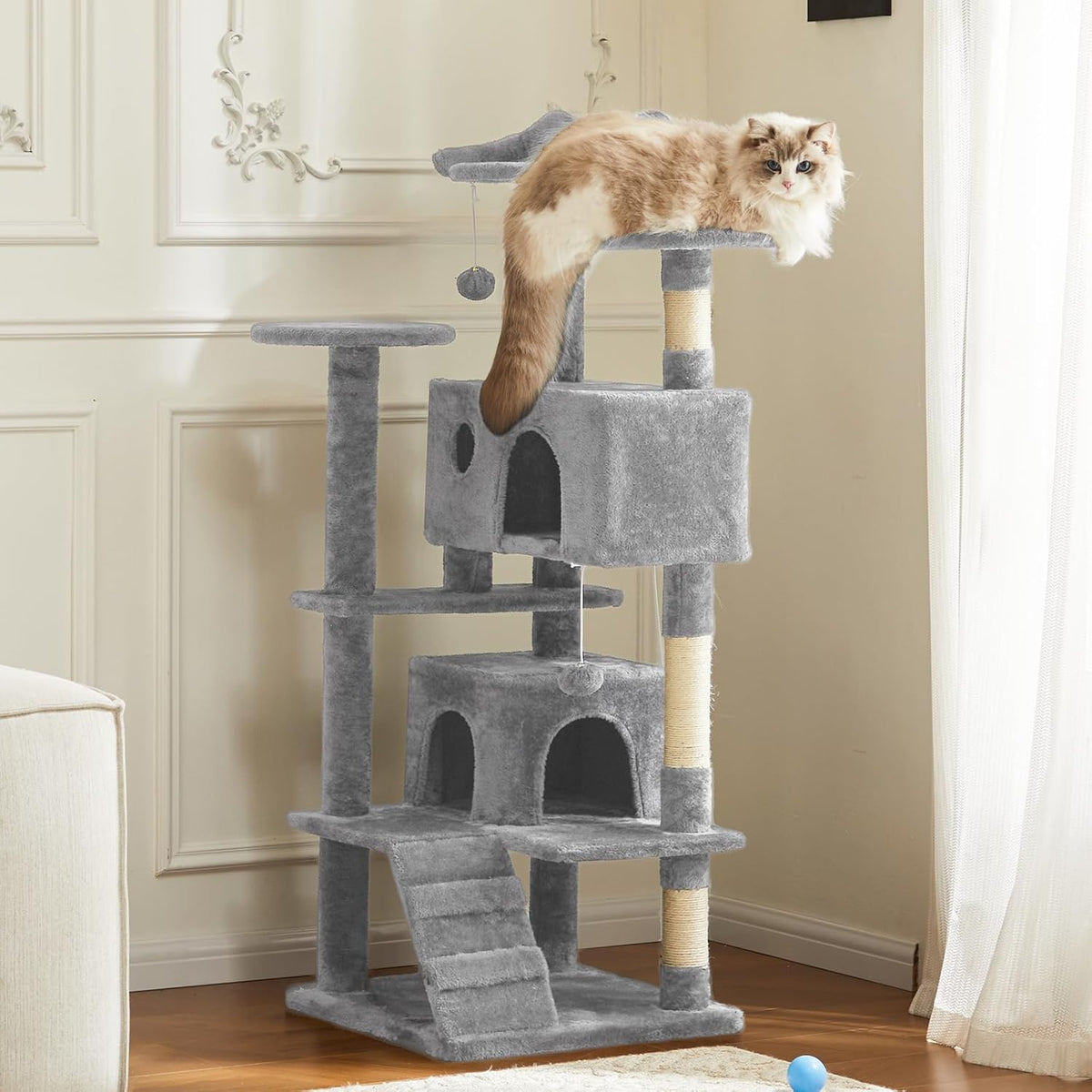 Cat tree tower in gray in a cozy living room corner