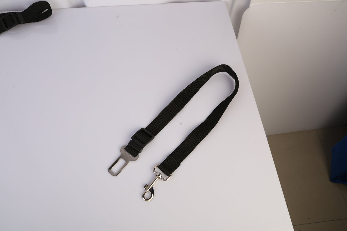 Adjustable pet car seat belt - nylon strap closeup on table